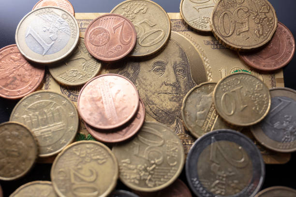istock Golden dollar and EURO coins 1255329402