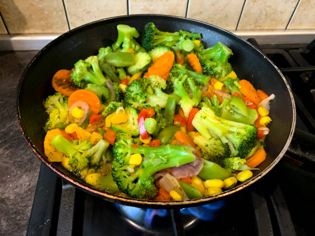 istock Mix of vegetables is fried in pan on stove 1255331127