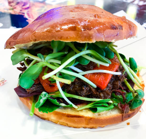 Burger with meat and green young sprouts