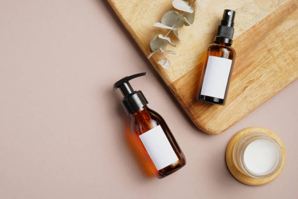 istock SPA natural organic cosmetics on beige background. Flat lay composition with amber glass pump bottle, sprayer, moisturizer cream jar, eucalyptus leaf. Top view. 1255333665