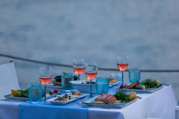 istock Various seafood dinner table ready at seaside with appetizers and drinks at afternoon 1255337804