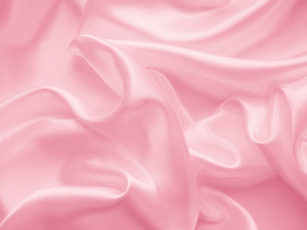istock Beautiful elegant wavy light pink satin silk. 1255339781