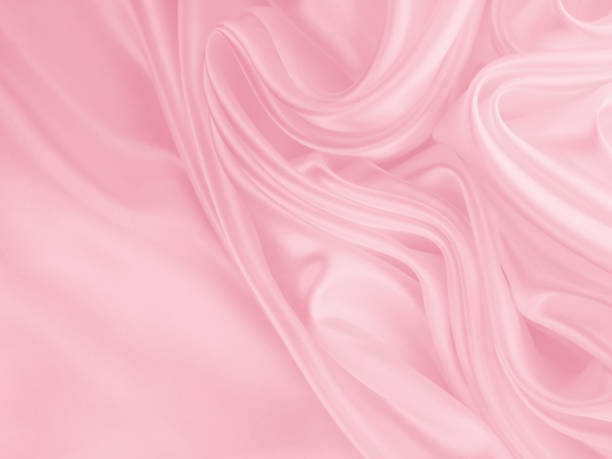 istock Beautiful elegant wavy light pink satin silk. 1255339785
