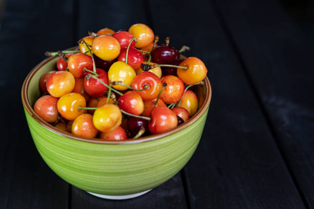istock Yellow cherries in a cup on a wooden background 1255343277