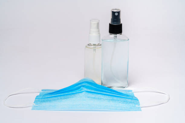 istock bottle of lotion, sanitizer or liquid soap and protective mask over light grey background 1255344783