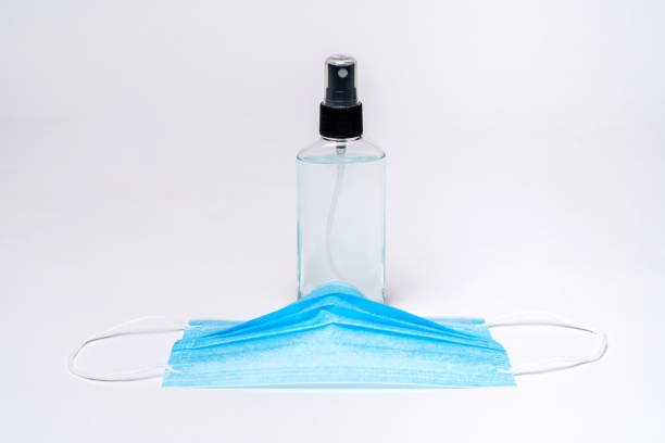 istock bottle of lotion, sanitizer or liquid soap and protective mask over light grey background 1255344785