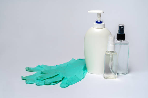 istock sanitizer liquid bottle and protective rubber latex disposable glove 1255344844