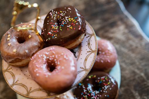 Vintage style composition of various flavors of donuts, photographed in macro still life