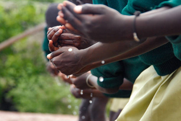 istock Caring Hands passing on water game pouring 1255347059