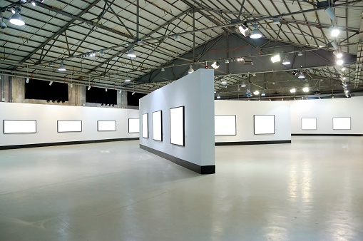 exhibition hall with empty frames on the wall