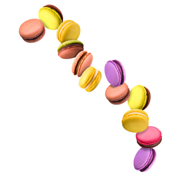 Set of flying french colorful macaroons isolated on white background