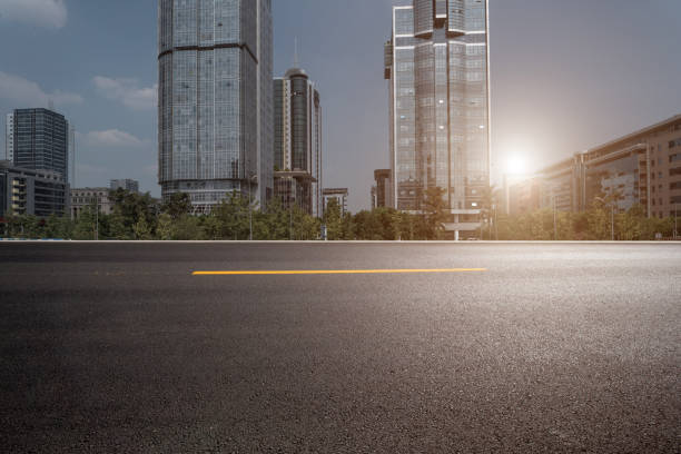 istock empty asphalt road in downtown with modern office buildings and skyline. 1255350601