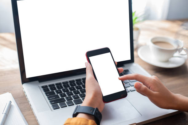 istock Woman holding blank screen mock up mobile phone and finger touching 1255352078