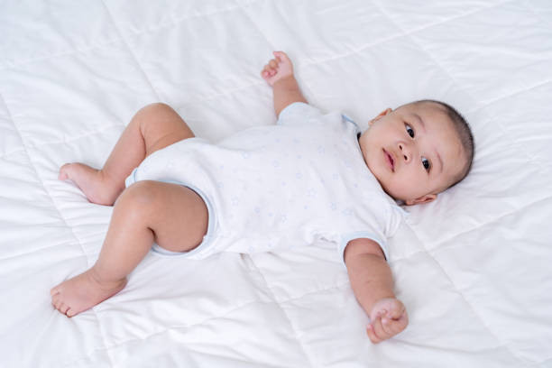 istock cheerful baby on a bed 1255353311