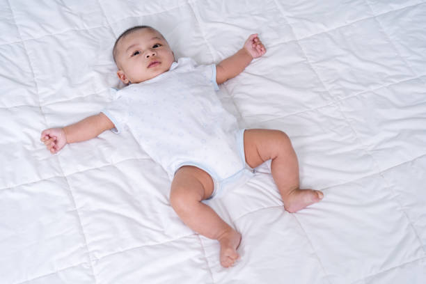 istock cheerful baby on a bed 1255353319
