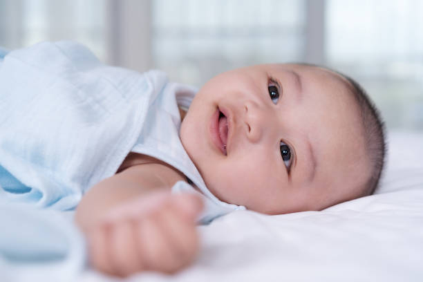 istock cheerful baby on a bed 1255353346