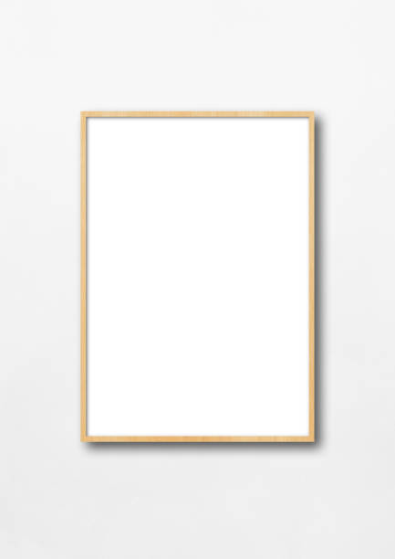 istock Wooden picture frame hanging on a white wall 1255353375