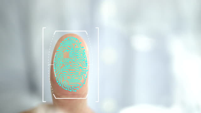 Businessman places thumb on a biometric glass scanner to scan and unlock the office security door