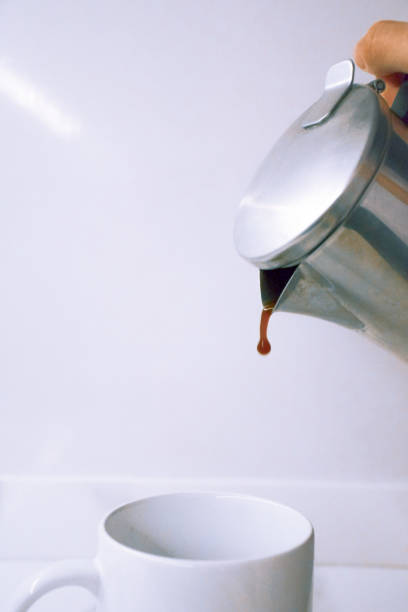 istock Coffee being poured from a coffee pot into a white cup 1255355257