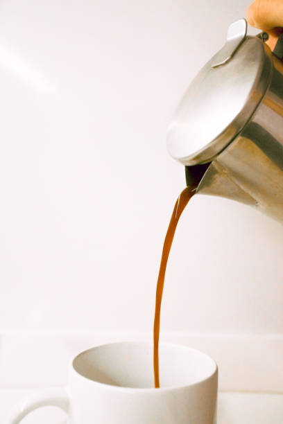 istock Coffee being poured from a coffee pot into a white cup 1255355260