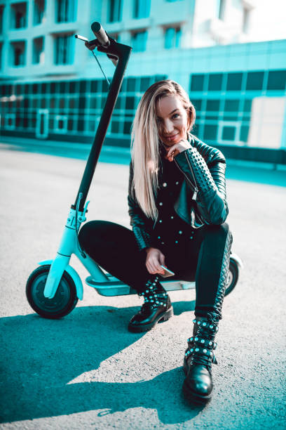 istock Female Resting From Riding Her Electric Scooter Outside Apartment Building 1255356321