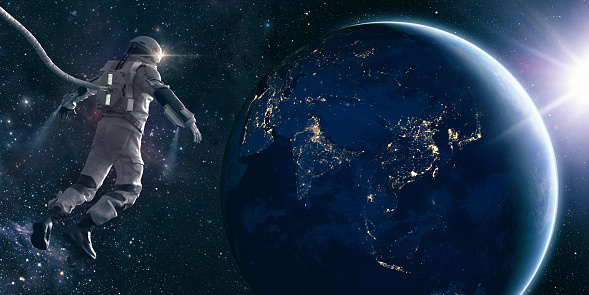 Astronaut spacewalk in space and touching orb of light. 3D render