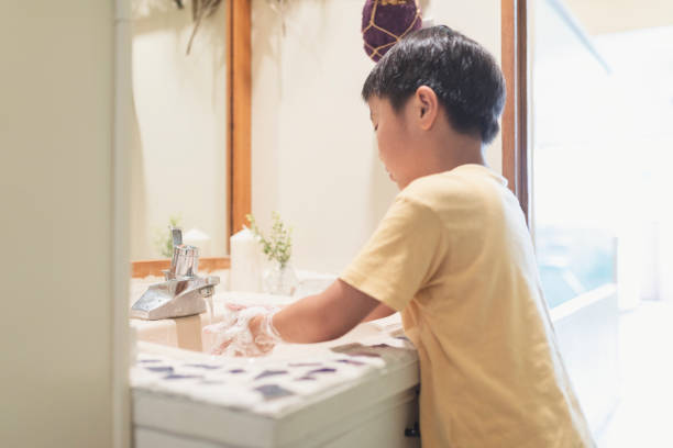 istock Boy washing hands in labotary at home 1255360288