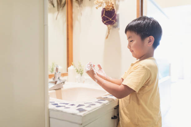 Boy washing hands in labotary at home