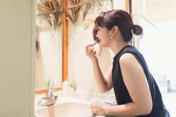 Asian woman using lipsticks in the washroom
