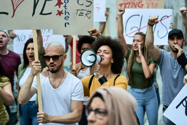 istock Multi-ethnic group of people protesting against racial discrimination on the streets. 1255361381