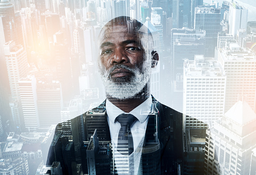 Portrait of a confident mature businessman superimposed on a city background