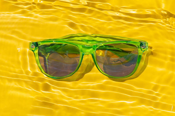 istock green sun glasses under yellow water 1255362443