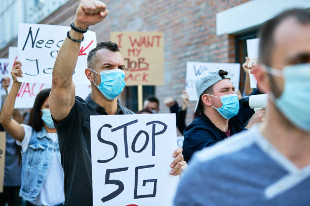 istock Crowd of people with protective face mask protesting against 5G network. 1255362517