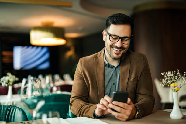 istock Cheerful man using smart phone in the restaurant, close-up, portrait. 1255362564