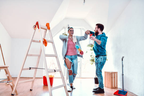 istock Couple Dancing And Cleaning Home Together 1255362613