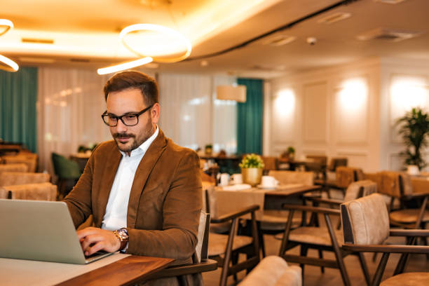 istock Charming entrepreneur working on laptop in luxurious restaurant, portrait. 1255362627
