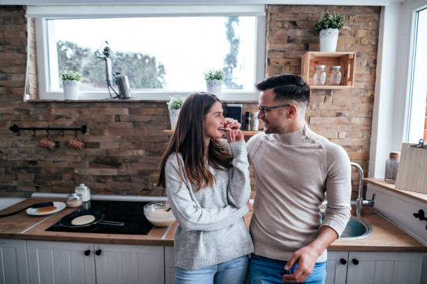 istock Cute couple in the kitchen, standing and looking at each other. 1255362704