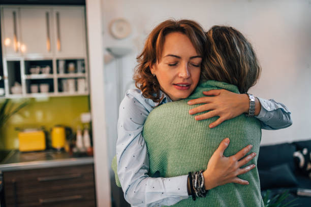 istock Portrait of a two affectionate women hugging at home. 1255363273