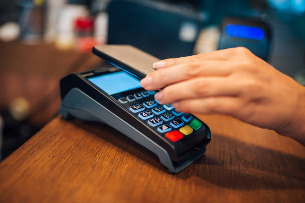 istock Woman making a contactless smartphone payment, close-up. 1255363293