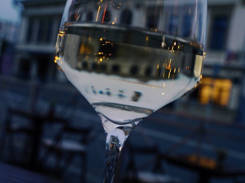 Evening glass of white wine in street bar