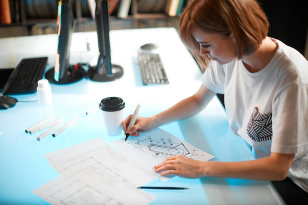 Young pretty creative woman designer is developing a new project, workspace in a creative company