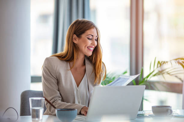 istock Successful young woman in modern office working on laptop. 1255368009