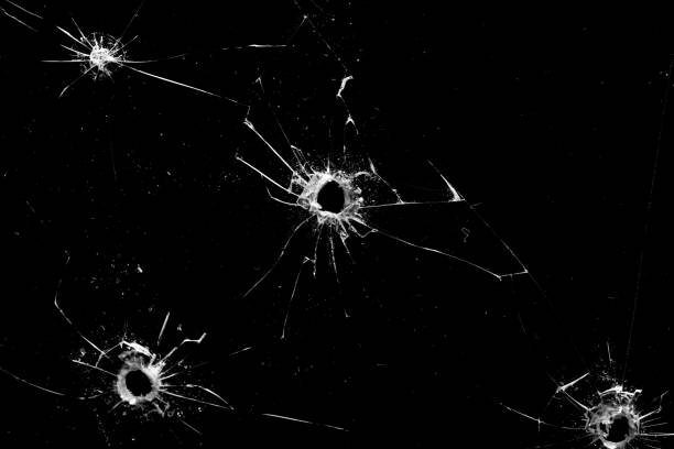 istock holes in the glass with cracks isolated on a black 1255368238