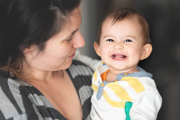 istock Mother and her little daughter are smiling 1255368737