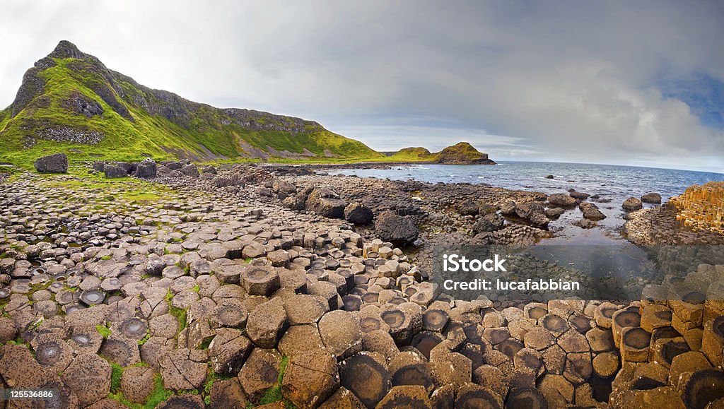 Giant's Causeway Panorama Panoramic view at the rocky coastline of the Giant’s Causeway in Northern Ireland. Giants Causeway Stock Photo