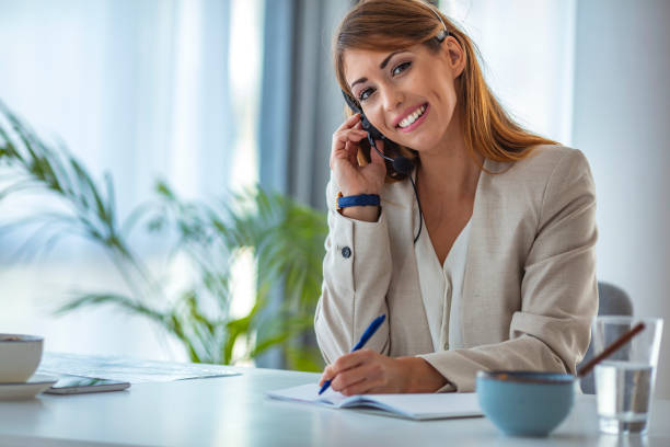 istock Customer support woman smiling and looking at camera. 1255369108