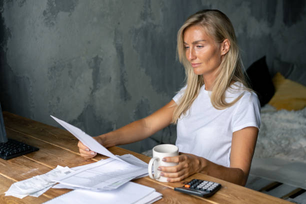 istock The woman at the table works with documents and bills. 1255370671