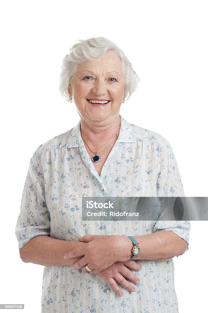 Smiling aged senior lady Happy smiling retired senior woman looking at camera isolated on white background. Senior Women Stock Photo