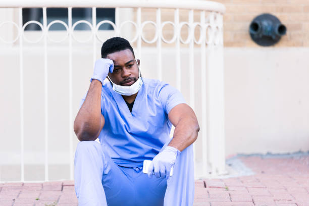 istock Concerned nurse takes shift break outdoors 1255371678