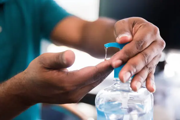 Photo of Businessman uses hand sanitizer at work